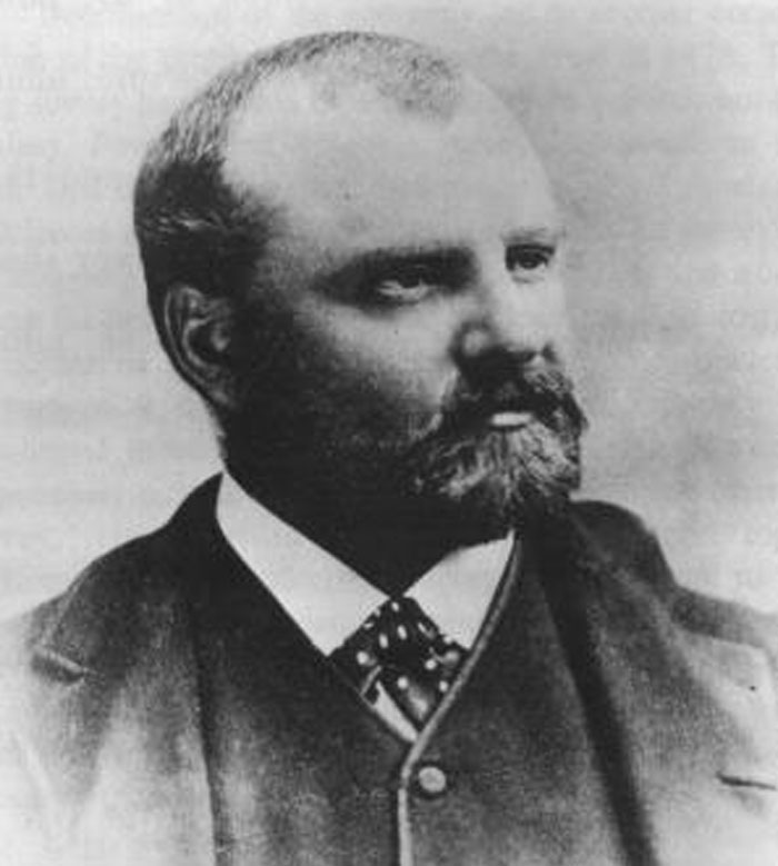 Black and white portrait of a bearded man in formal wear illustrating cool facts about the world people learned this June.