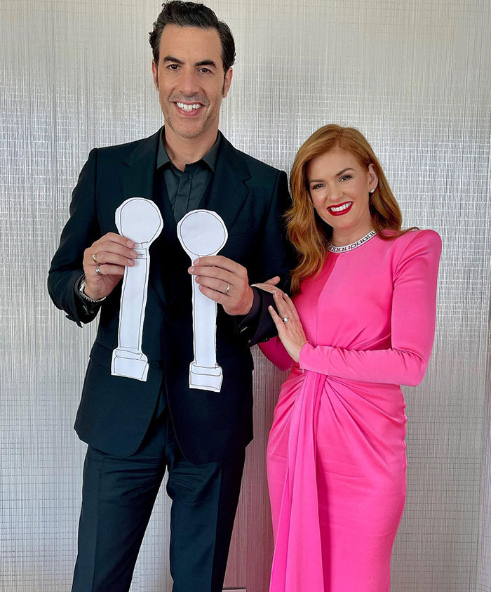 Isla Fisher and Sacha Baron Cohen posing together, Isla wearing a pink dress and sharing a message about marriage. - 17