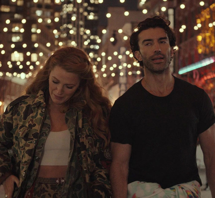 Blake Lively walking with a man at night under city lights, showcasing a casual and candid moment. - 12