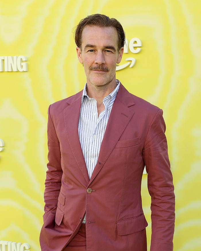 James Van Der Beek in a maroon suit, posing against a yellow backdrop during his cancer journey with difficult moments with kids. - 1