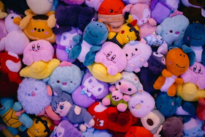 Pile of colorful plush toys representing trends leading to overconsumption and growing concerns about excess buying. - 16