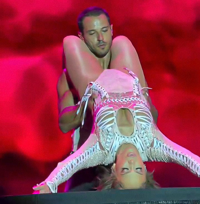 Jennifer Lopez performing raunchy dance moves with a male dancer in a controversial and provocative show.