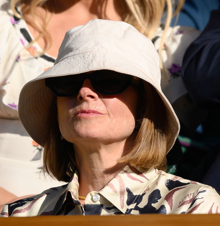 Woman wearing a beige bucket hat and sunglasses at Wimbledon 2025, showcasing a notable celebrity look in the crowd.