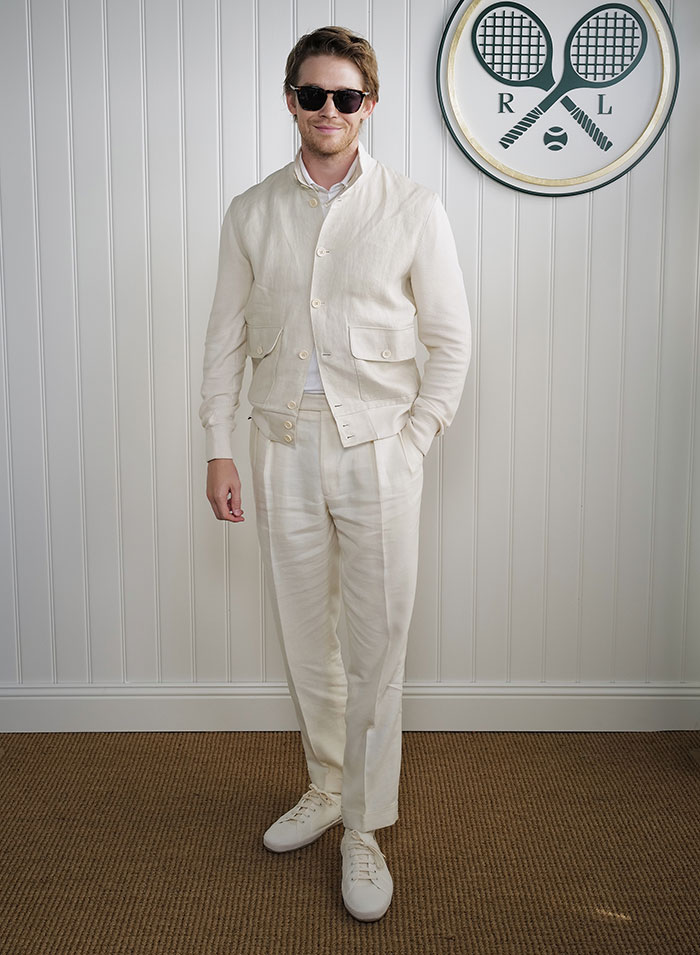 Man in cream outfit and sunglasses posing at Wimbledon event showcasing celebrity looks from 2025.