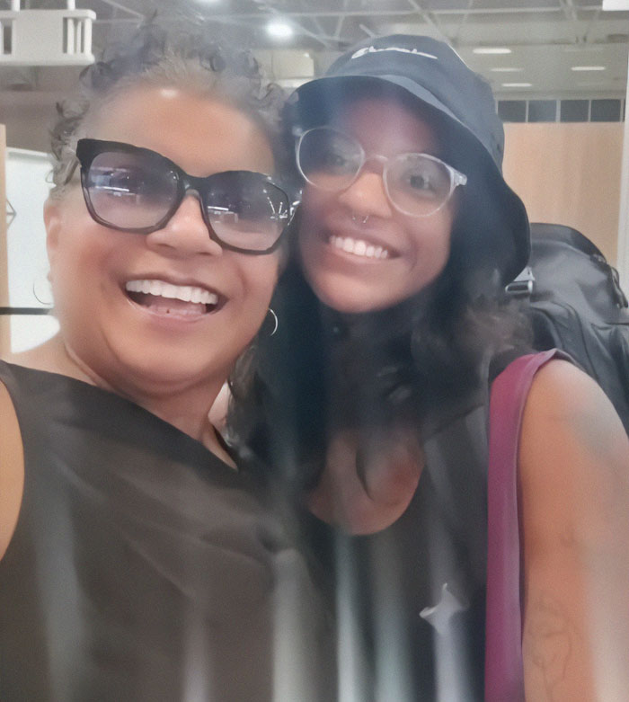Mother and daughter smiling together at an indoor location, related to hiker abandoned inside active volcano story.
