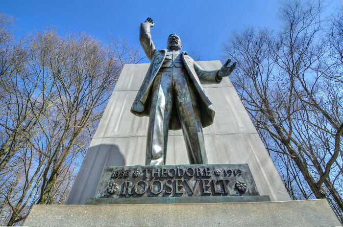 Statue of Theodore Roosevelt illustrating bravery that changed the course of history beneath a clear blue sky. - 13
