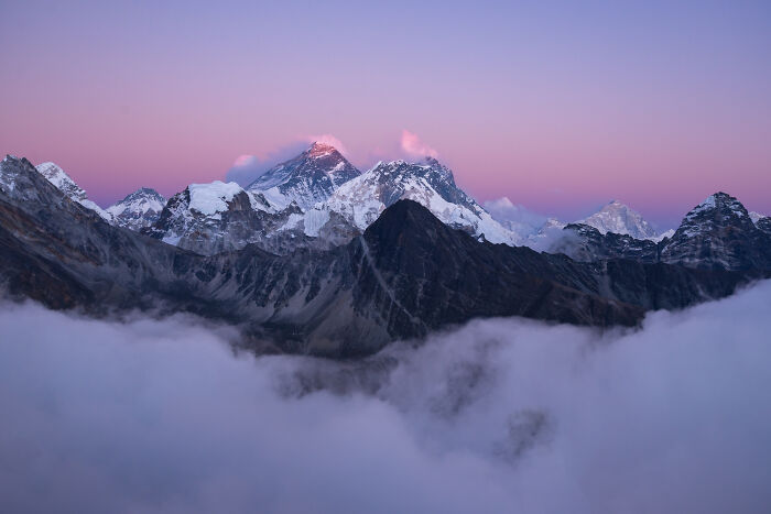 Snow-capped mountain peaks at sunrise with clouds below, symbolizing bravery that changed the course of history. - 31