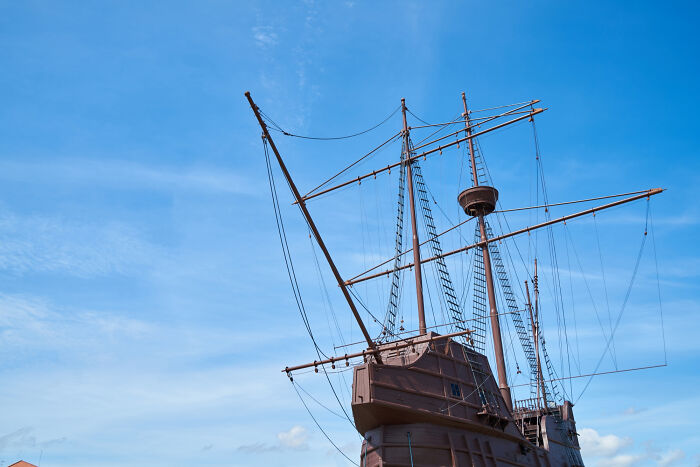 Historic wooden ship with tall masts and rigging under a clear blue sky representing bravery changing history. - 28