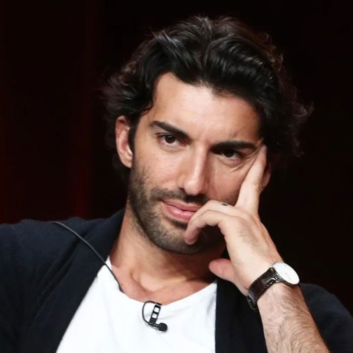 Man with dark hair wearing a watch, resting his head on hand, reflecting on Blake Lively given reality check in court. - 2