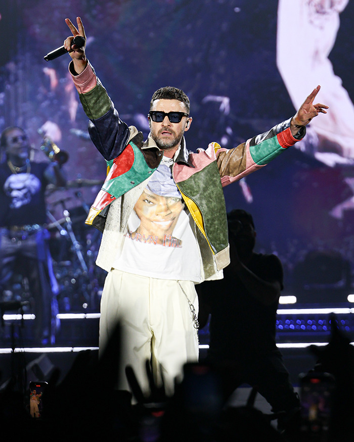 Justin Timberlake performing on stage, wearing sunglasses and colorful jacket, revealing Lyme disease battle after Romania show. - 2