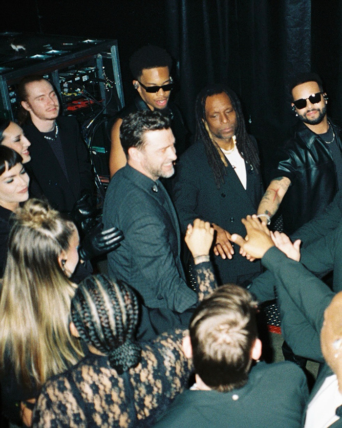 Justin Timberlake with team backstage, showing support amid Lyme disease battle after Romania show difficulties. - 4