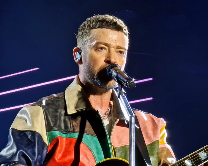 Justin Timberlake performing live on stage, wearing a colorful leather jacket, sharing his Lyme disease battle. - 5