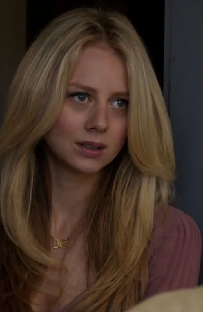 Justine Lupe in a close-up shot portraying a character with long blonde hair in a dramatic screen performance.