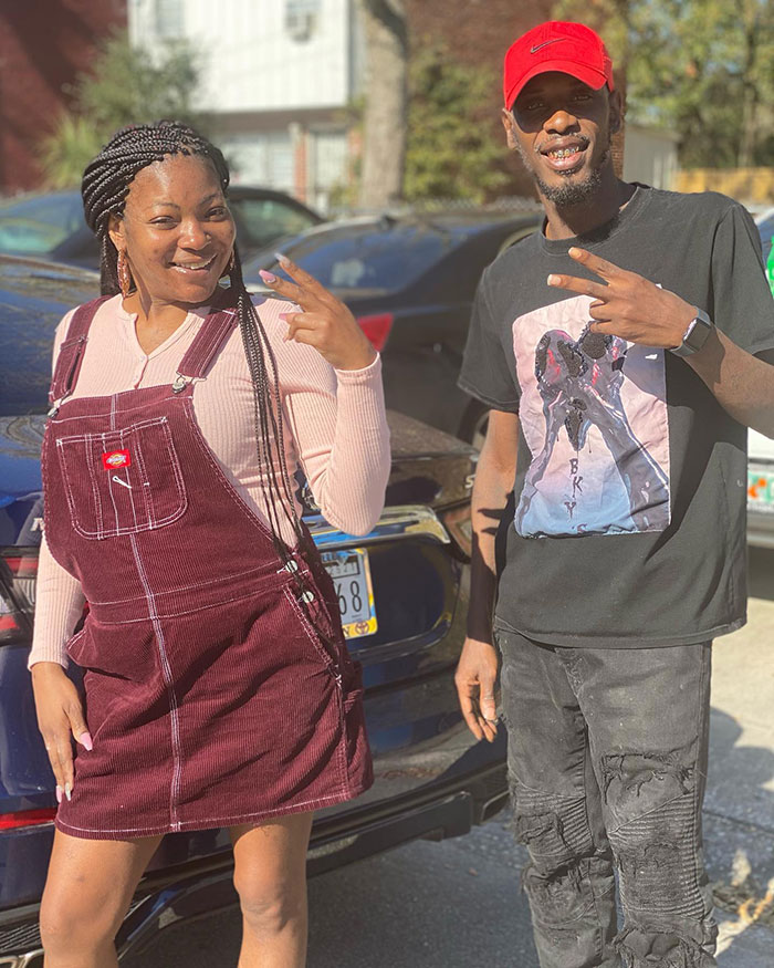 Woman abducted from hospital at 8 hours old poses outdoors with a man, both smiling and showing peace signs. Woman abducted from hospital at 8 hours old poses outdoors with a man, both smiling and showing peace signs.