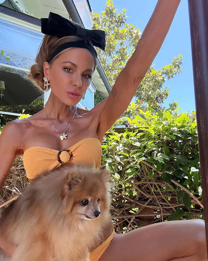 Kate Beckinsale posing outdoors wearing an orange bikini with a small fluffy dog, showing drastic weight loss and a thin look. Kate Beckinsale posing outdoors wearing an orange bikini with a small fluffy dog, showing drastic weight loss and a thin look.