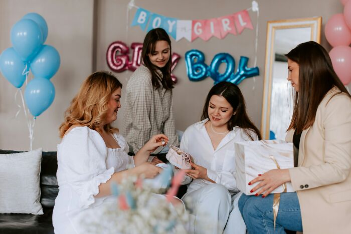 A group of women celebrating with gifts and decorations at a party, highlighting trends leading to overconsumption. - 2