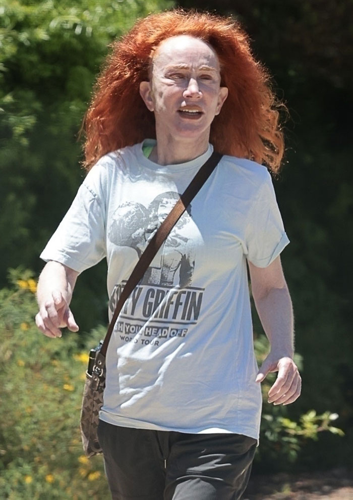 Kathy Griffin walking outdoors with red hair and casual clothes, showing a natural transformation sparking meme frenzy.