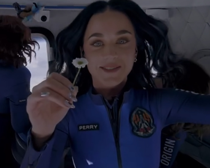 Katy Perry in a blue jumpsuit holding a small flower, related to Katy Perry and Orlando Bloom breakup news. Katy Perry in a blue jumpsuit holding a small flower, related to Katy Perry and Orlando Bloom breakup news.