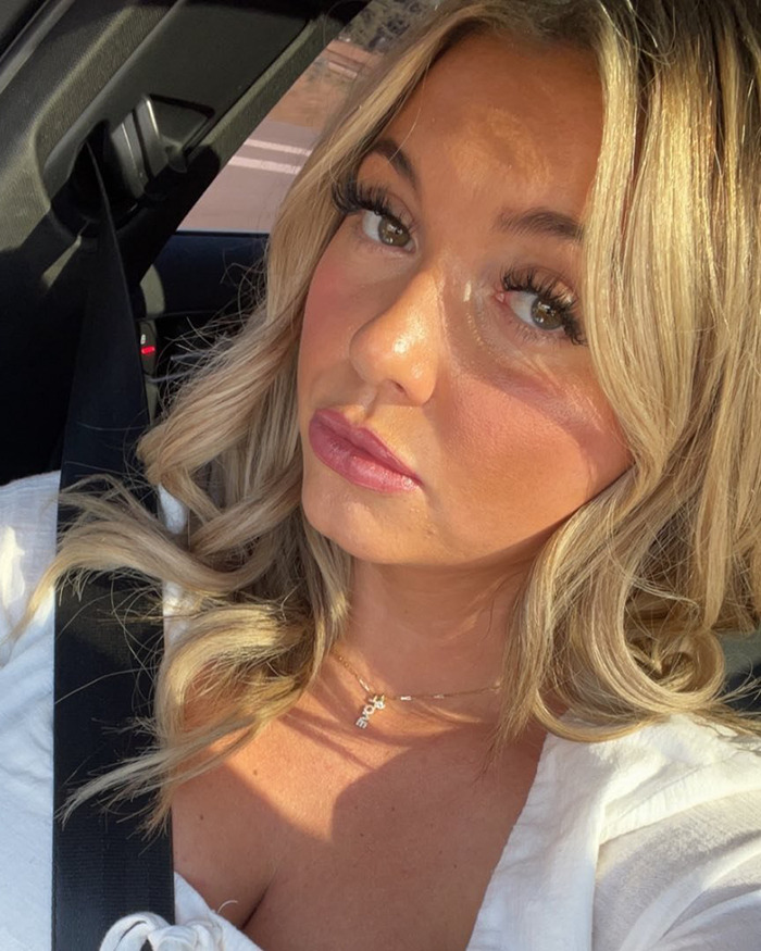 Woman with blonde hair in a car, sharing emotional details about her daughter's violent massacre victim experience.