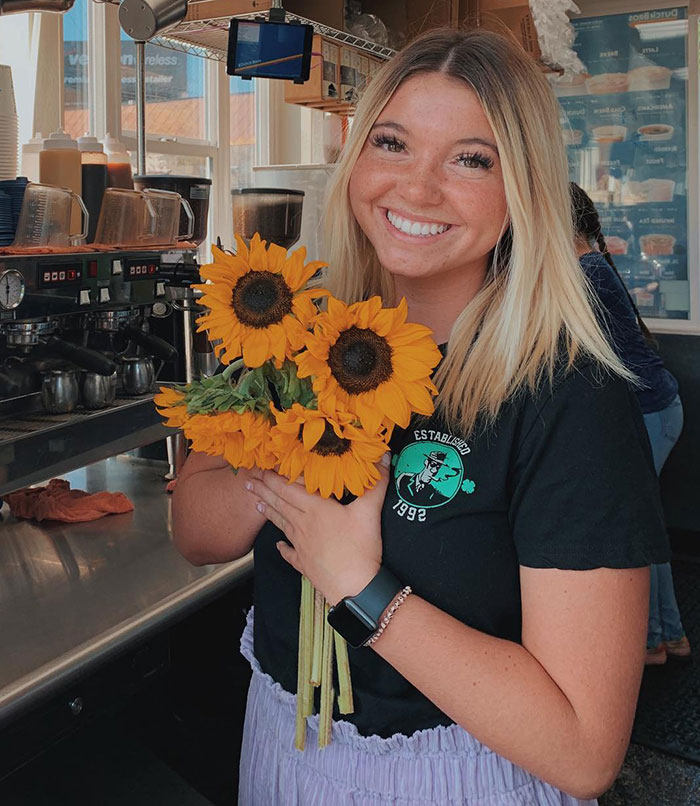Young woman smiling and holding sunflowers indoors, related to massacre victim Kaylee Goncalves’ sister revealing her takedown of Bryan Kohberger. Young woman smiling and holding sunflowers indoors, related to massacre victim Kaylee Goncalves’ sister revealing her takedown of Bryan Kohberger.