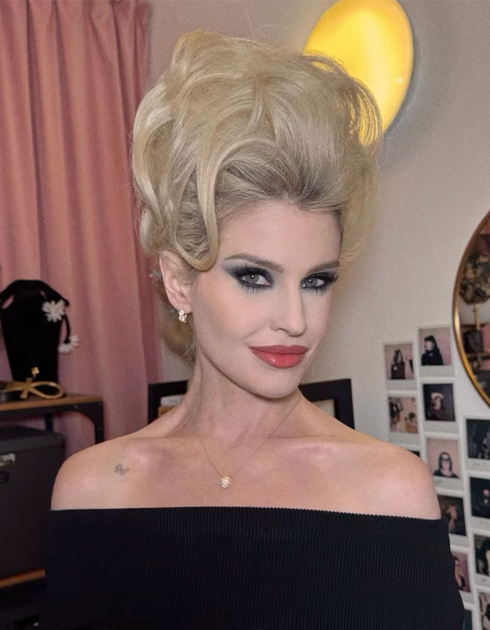 Kelly Osbourne with 90s glam fashion style, vintage hairstyle, bold makeup, and off-shoulder black outfit indoors. Kelly Osbourne with 90s glam fashion style, vintage hairstyle, bold makeup, and off-shoulder black outfit indoors.