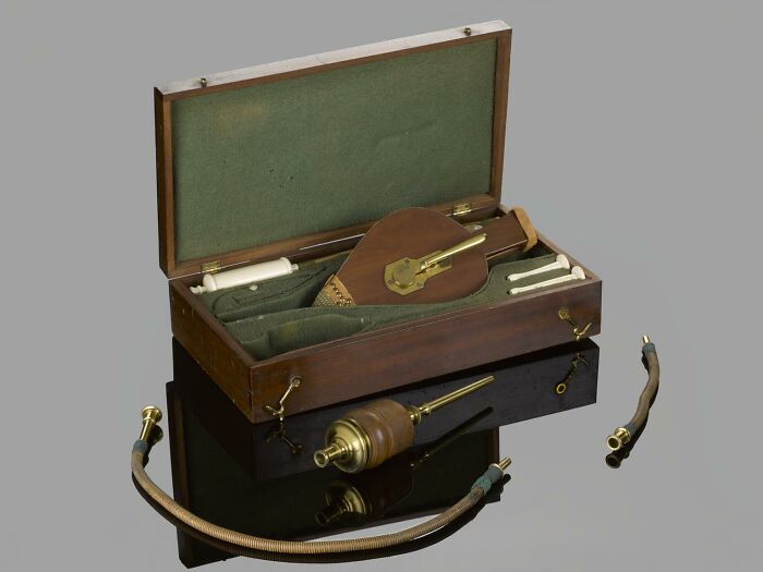 Antique medical device kit with brass components and leather case, showcasing unsettling medical devices from the past.