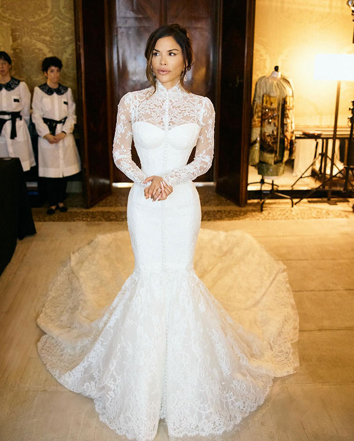Lauren Sanchez wearing a lace wedding dress posing indoors with attention on photoshopped wedding pictures editing blunders.