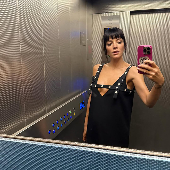 Lily Allen taking a selfie in an elevator wearing a black dress, linked to her confession about abortions dividing the internet.