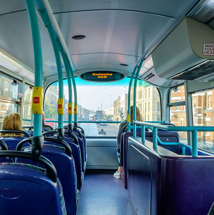 Interior of a bus with passengers seated, highlighting a scene related to bus passenger and stolen AirPods incident. - 1