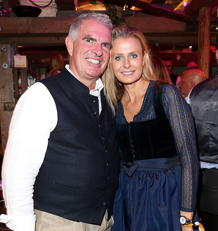 Couple posing at an event, related to the family of babysitter fatally hit by wife of Lufthansa CEO after sudden passing.