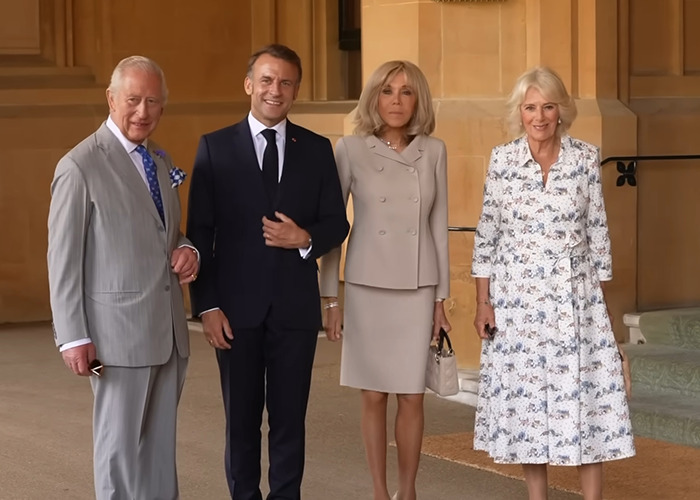 Prince Charles, Emmanuel Macron, Brigitte Macron, and Camilla Parker Bowles posing during France visit with lip reader interest. Prince Charles, Emmanuel Macron, Brigitte Macron, and Camilla Parker Bowles posing during France visit with lip reader interest.