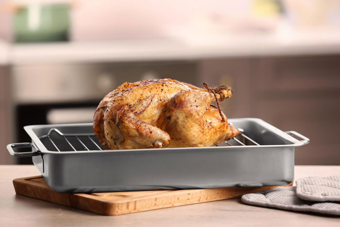 Roasted chicken cooling in a pan, illustrating concerns about raw chicken left in trunk and biohazard risks. - 1