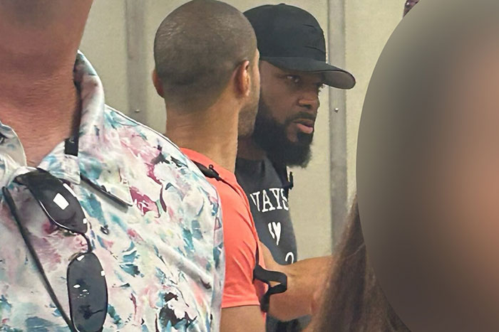 Malcolm-Jamal Warner in a candid moment wearing a black cap and shirt during one of his final public appearances. - 3