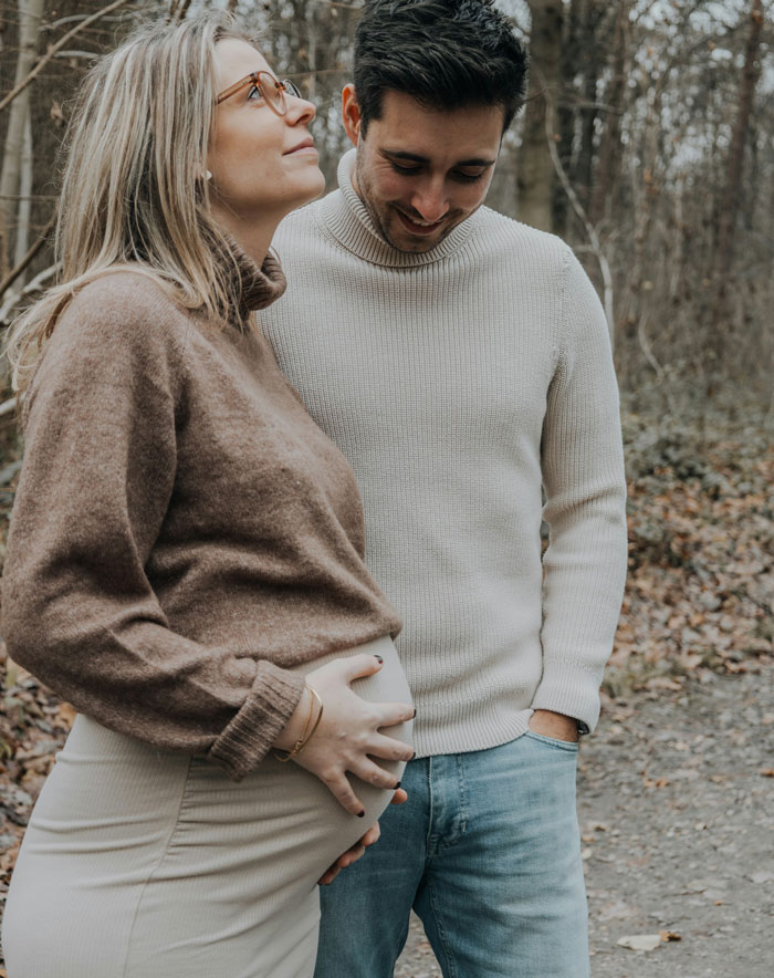 Man and pregnant woman outdoors, symbolizing family conflict and issues with vengeful ex relationships in a natural setting. - 6