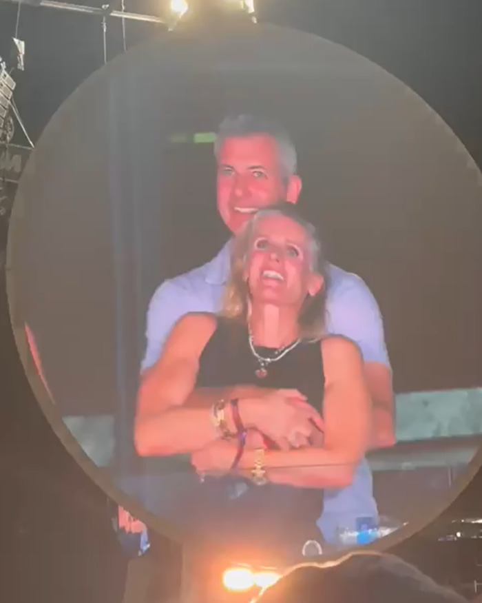 Man and woman smiling and hugging at an event after cheating scandal and sociopath CEO school story shared.