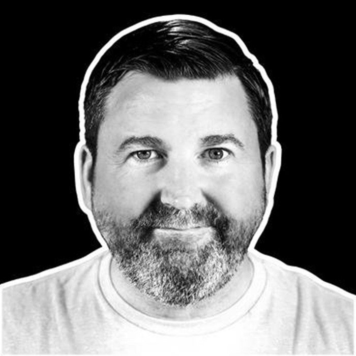 Black and white portrait of a bearded man sharing a violent school story about sociopath CEO after cheating scandal.