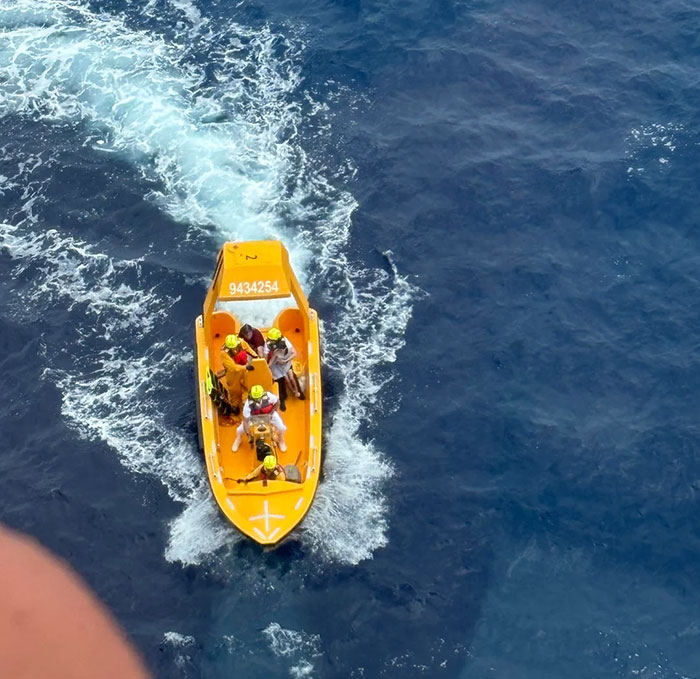 Rescue boat with crew on the ocean during a police operation related to viral cruise ship incident involving dad and daughter.