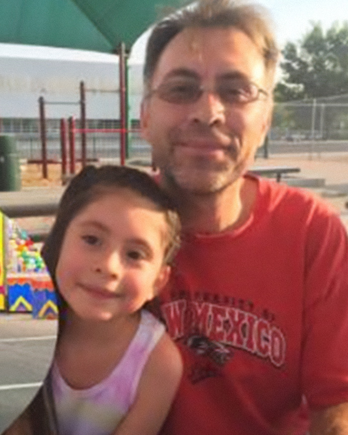 Man and child posing outdoors at a playground, related to man slays entire family and dog news story.