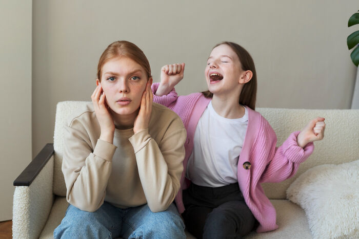 Two girls on a couch showing contrasting emotions, illustrating advice kids were given and manipulation in disguise. - 19