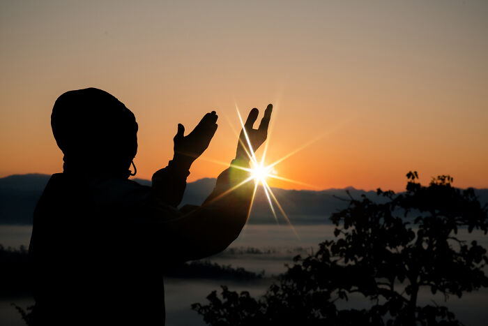 Silhouette of a child reaching towards the sunrise, symbolizing advice kids were given that felt like manipulation. - 20