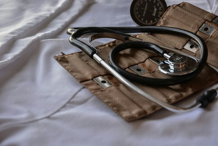 Close-up of a stethoscope and blood pressure cuff on white fabric, symbolizing stories from married people feeling trapped in relationships.