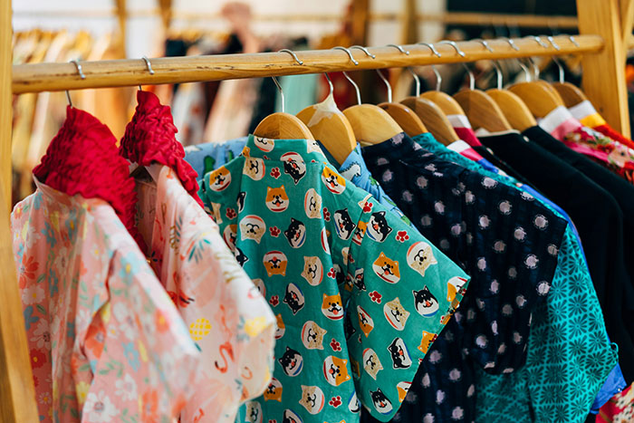 Clothing rack with colorful patterned dresses, highlighting style trends related to wife obsessed with looking like an Asian child. Clothing rack with colorful patterned dresses, highlighting style trends related to wife obsessed with looking like an Asian child.