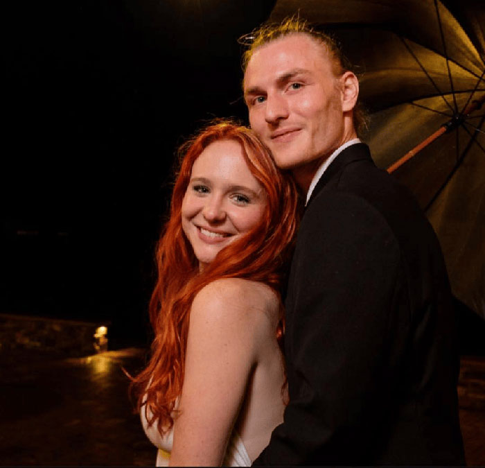 Couple posing together at night, unrelated to Virginia councilman set on fire incident mentioned in the news.