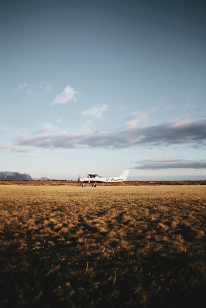 Small plane on a field during golden hour with open sky, relating to PIs and their weirdest cases outdoors. - 18