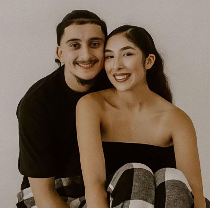 Young couple sitting closely together, smiling, related to mass outrage over baby left in car incident. Young couple sitting closely together, smiling, related to mass outrage over baby left in car incident.
