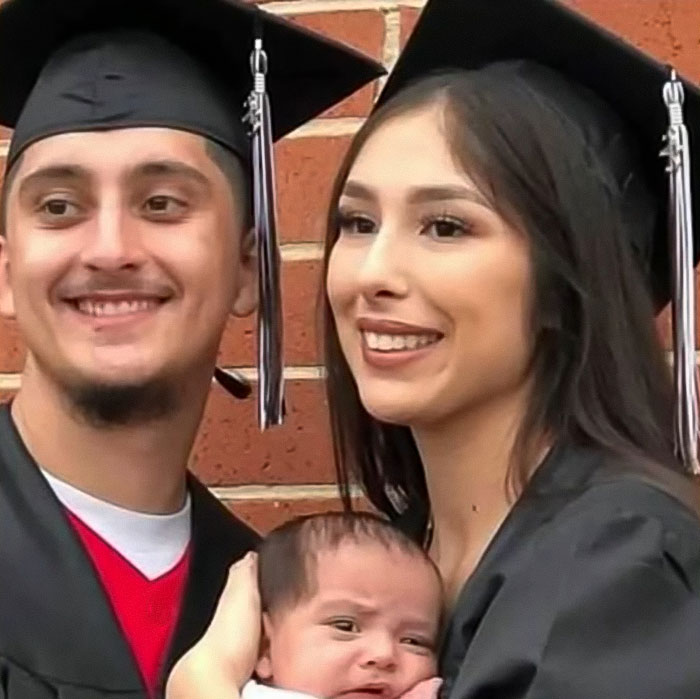 Young couple in graduation gowns holding a baby, related to mass outrage over baby who passed away in car incident. Young couple in graduation gowns holding a baby, related to mass outrage over baby who passed away in car incident.