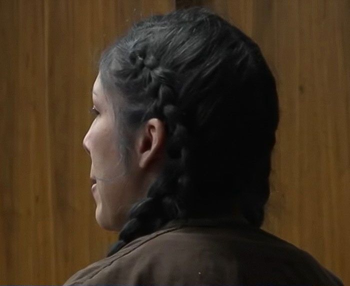 Woman with braided hair seen from side in a courtroom setting related to baby passing away after mom left him in the car for lip filler Woman with braided hair seen from side in a courtroom setting related to baby passing away after mom left him in the car for lip filler