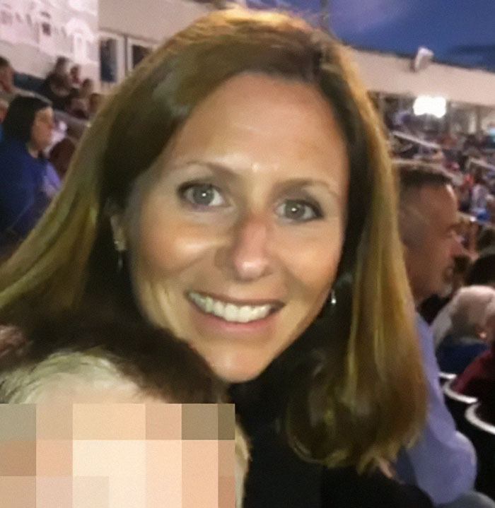 Smiling woman at an outdoor event, with blurred crowd in the background, illustrating story about sociopath CEO after scandal.