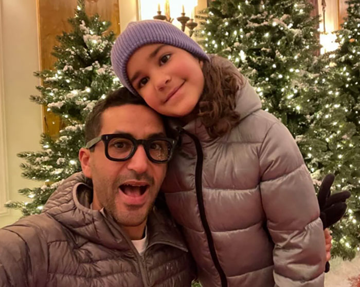 Father and daughter in winter clothing with Christmas trees in background highlighting inconsistencies in missing girl report by police