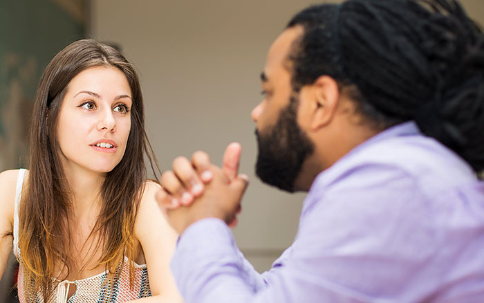 A man and woman having a serious conversation, illustrating things men shouldn’t do while pursuing women. - 9